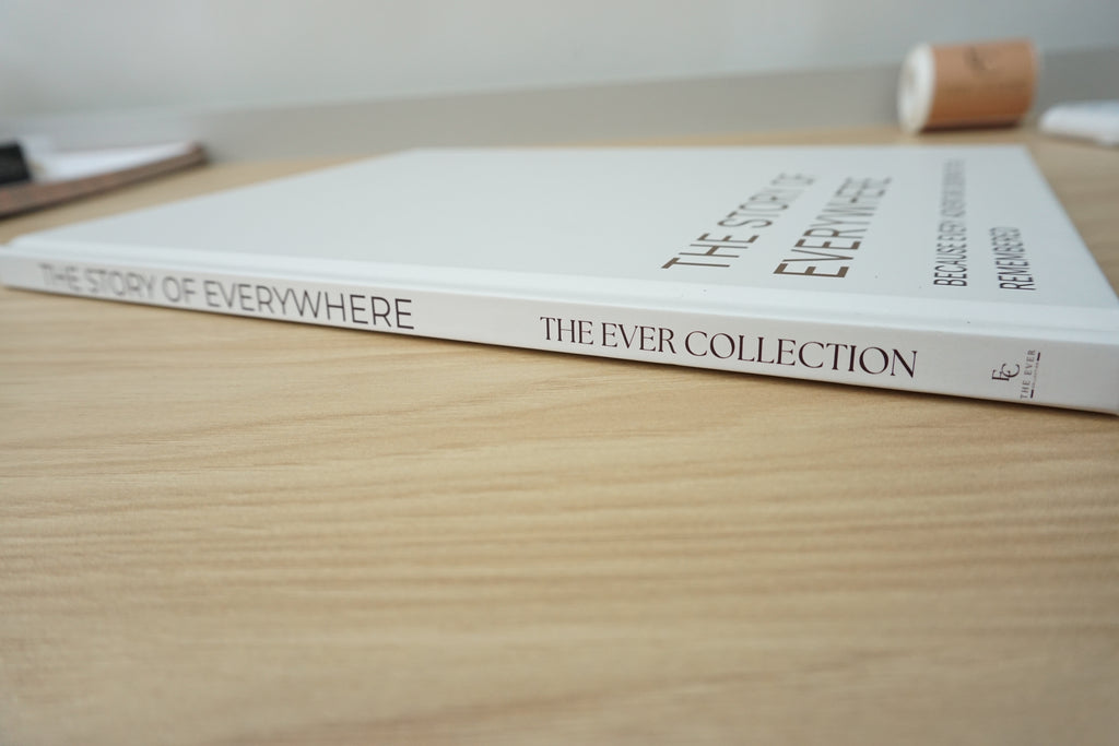 A stone hardcover book titled 'The Story of Everywhere: The Ever Collection' resting on a light wood tabletop.