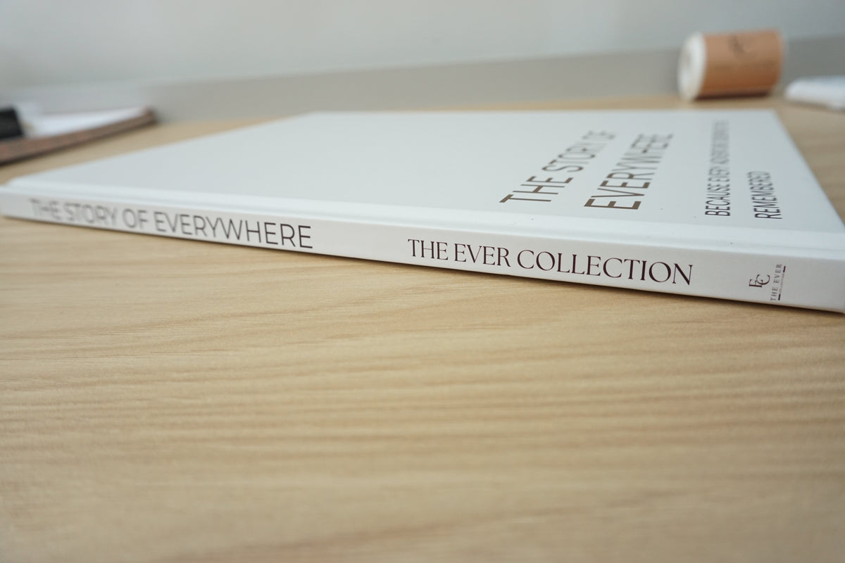 A stone hardcover book titled 'The Story of Everywhere: The Ever Collection' resting on a light wood tabletop.